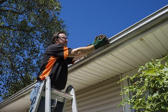 two workers fixing a gutter on a residential house in Canoga Park CA